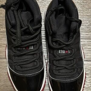 Air Jordan 11 Retro Black and red sneakers. Size 4 youth.